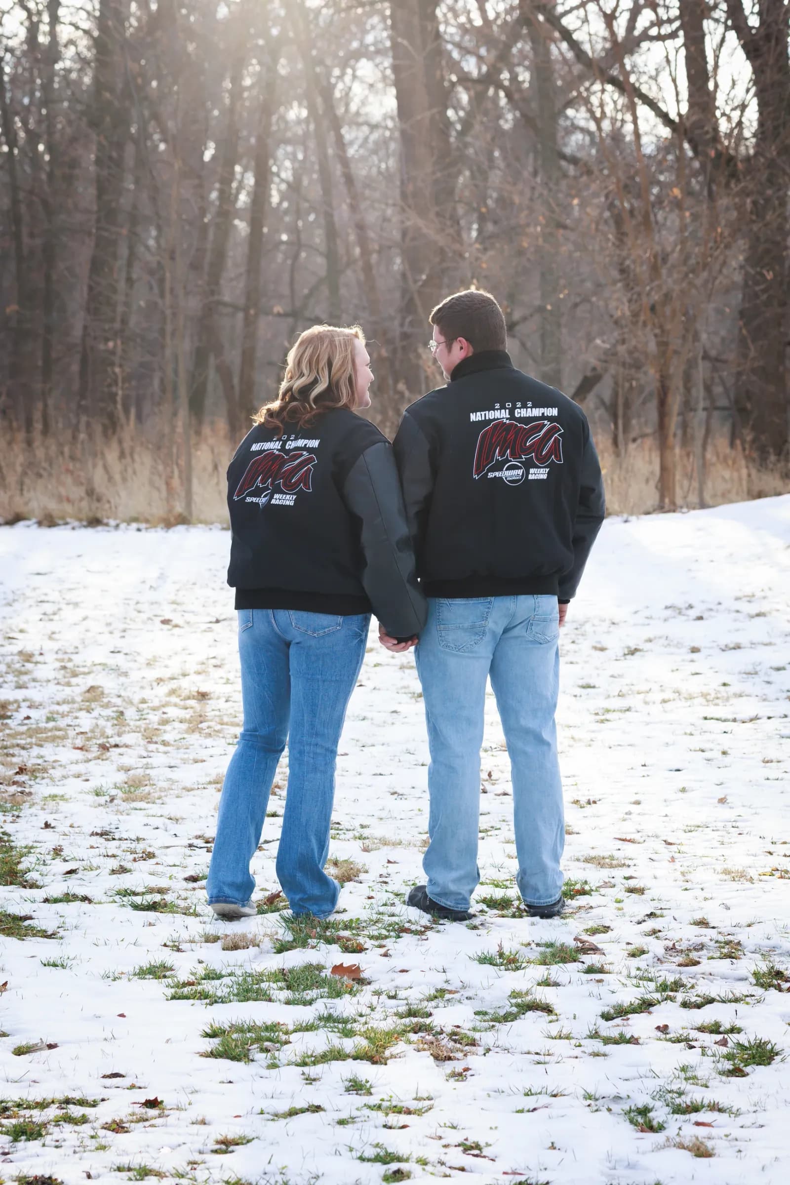 Couple in championship racing jackets in snow