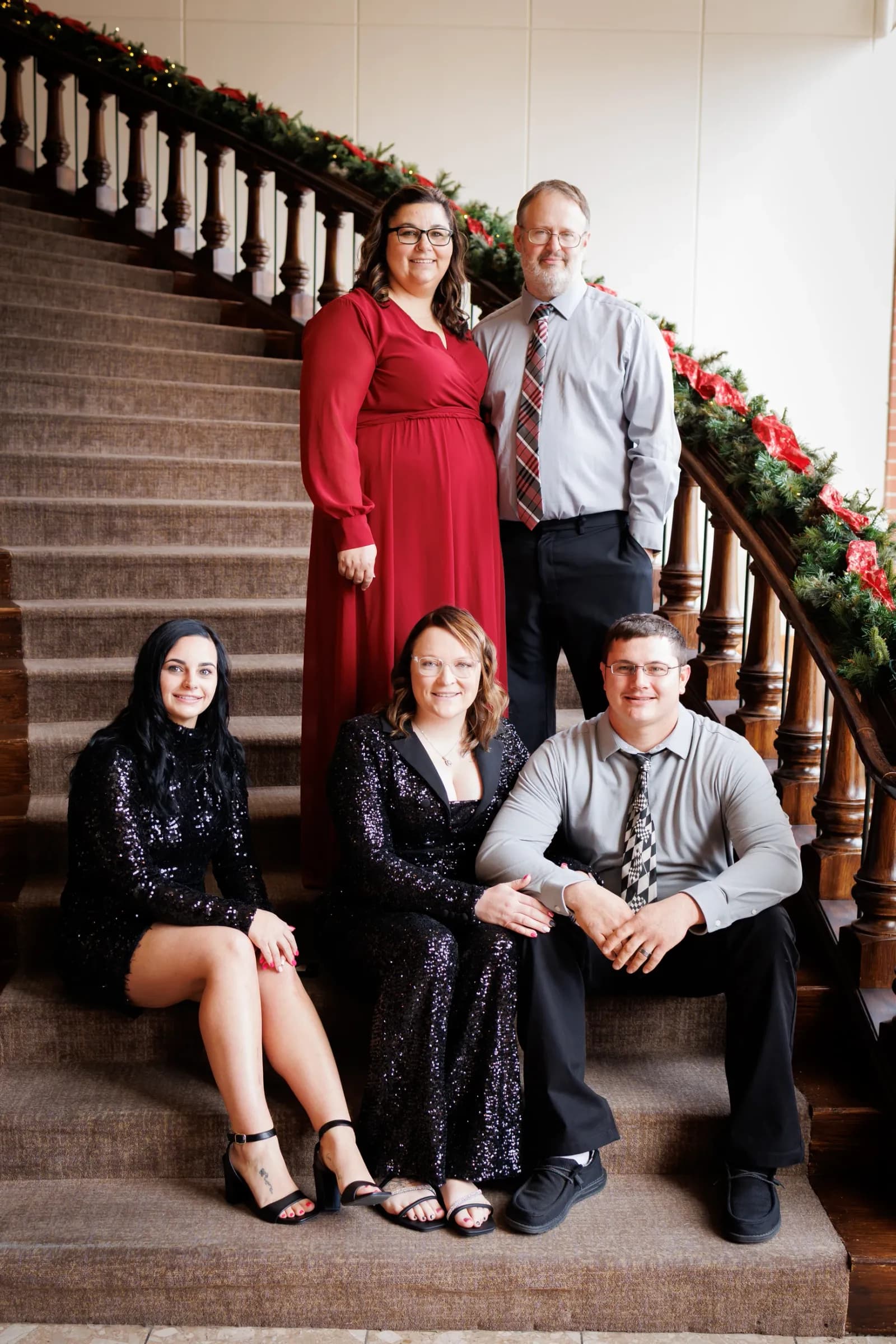 Family of 5 adults posted on staircase