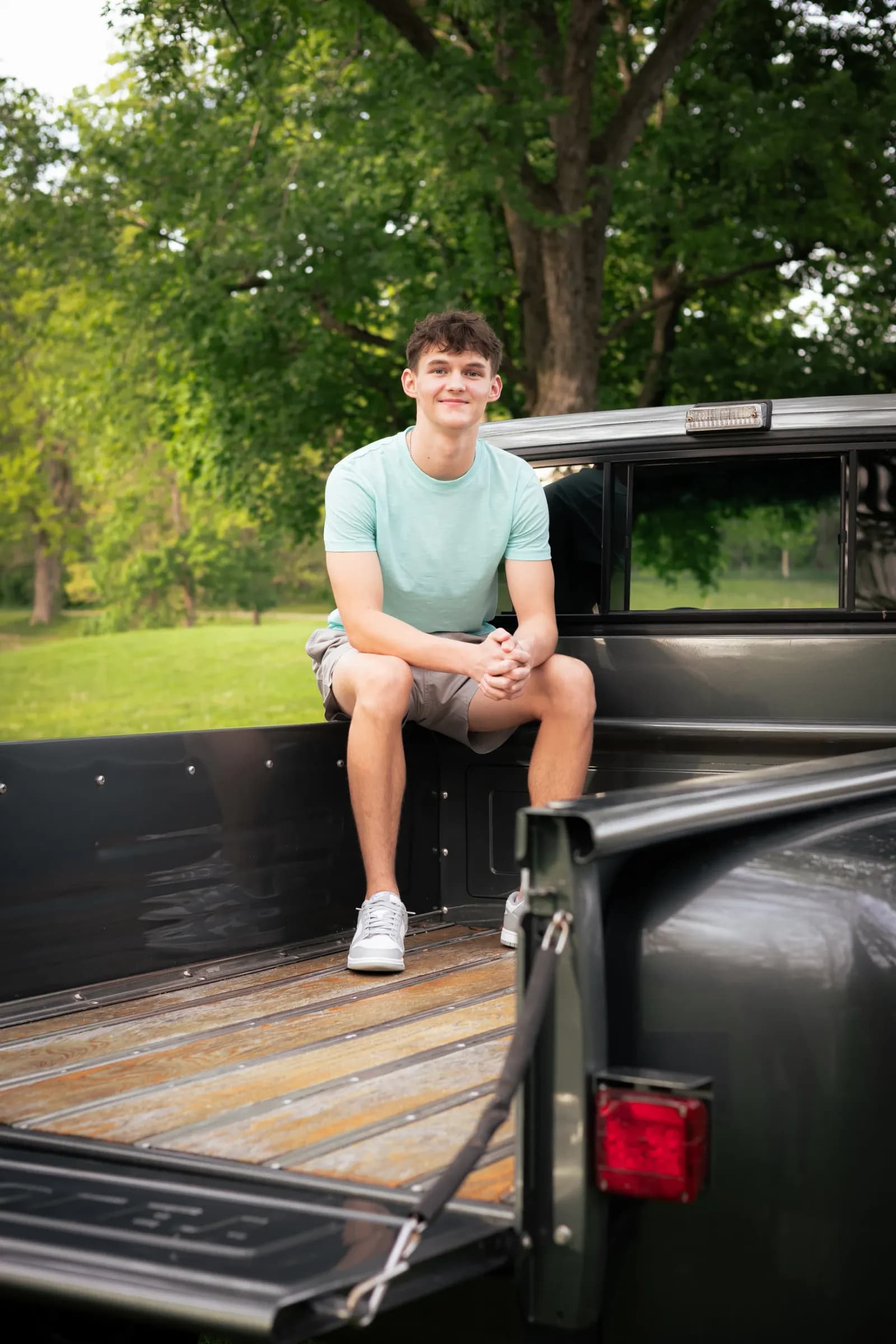 Senior boy Sitting in bed of vintage truck
