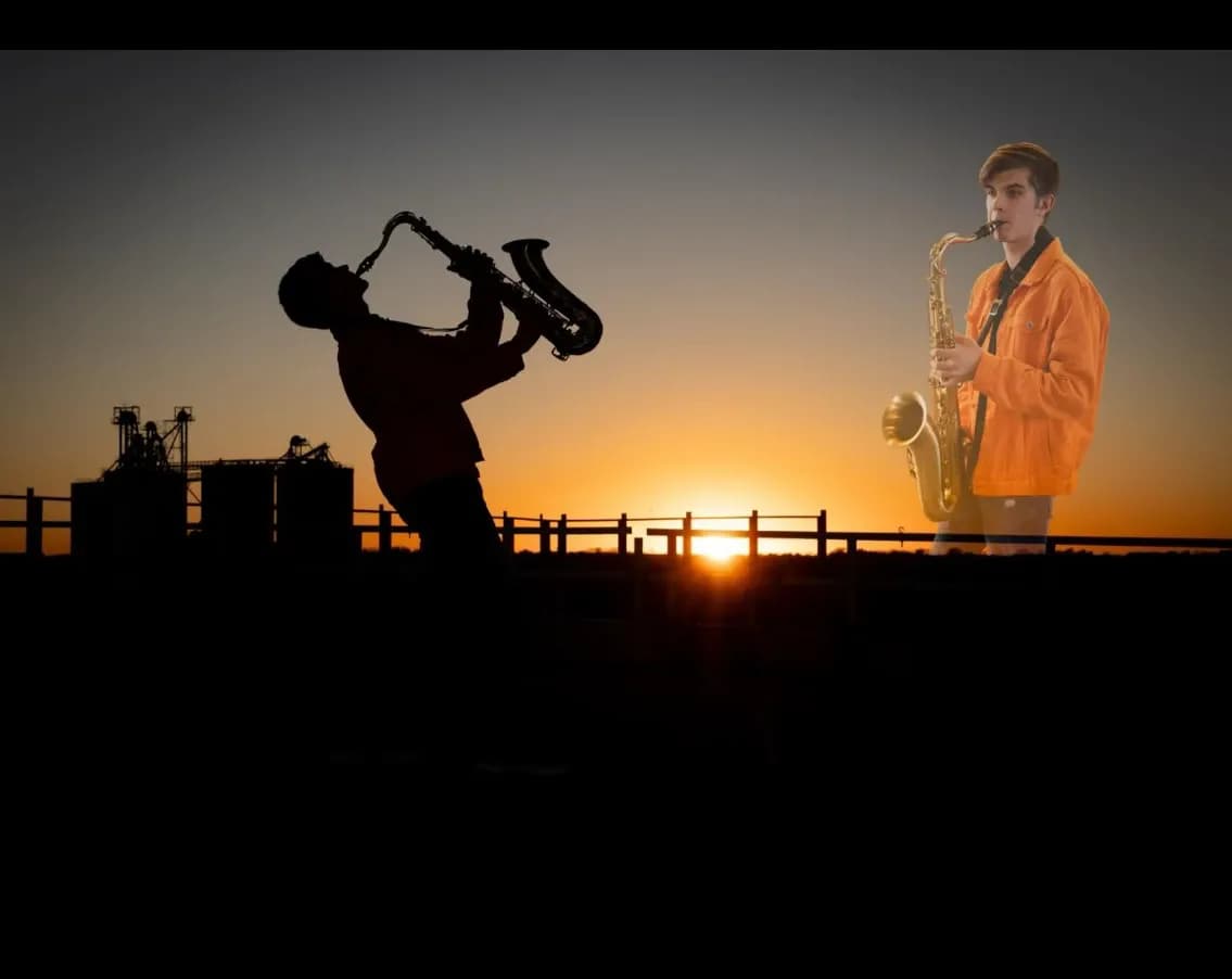 Silhouette of boy playing saxophone at sunset