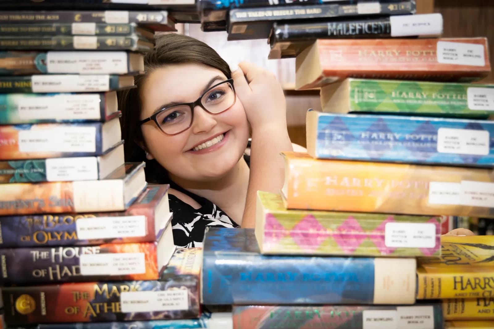 Senior Girl in stacks of books
