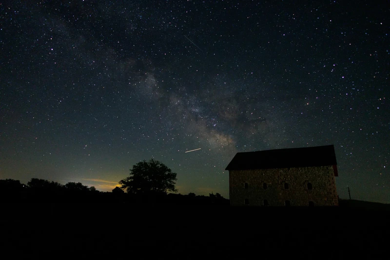 Milky Way over silhouette of barn