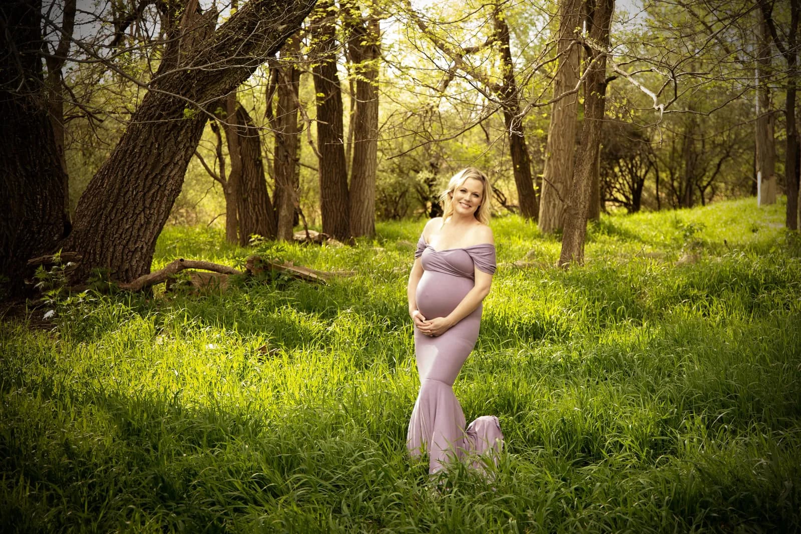 Women in maternity gown in tall grass